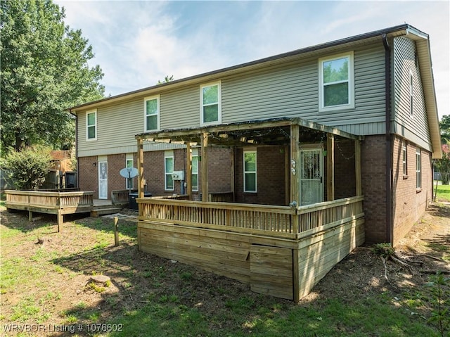 back of house featuring a wooden deck