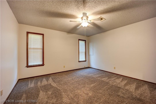 unfurnished room featuring ceiling fan, carpet floors, a textured ceiling, and electric panel