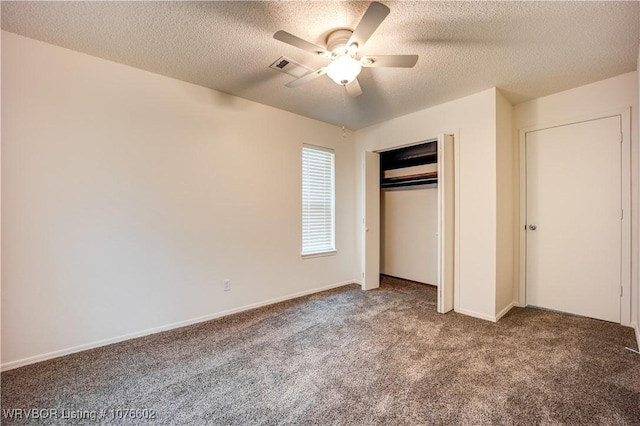 unfurnished bedroom with carpet, a textured ceiling, a closet, and ceiling fan