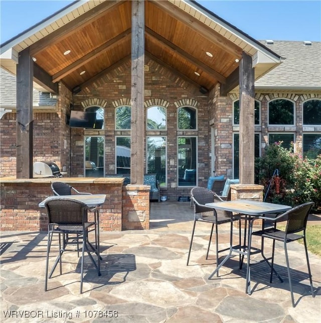 view of patio / terrace featuring a grill, area for grilling, and an outdoor bar