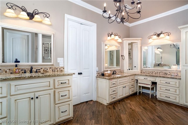 bathroom with decorative backsplash, a notable chandelier, wood-type flooring, ornamental molding, and vanity