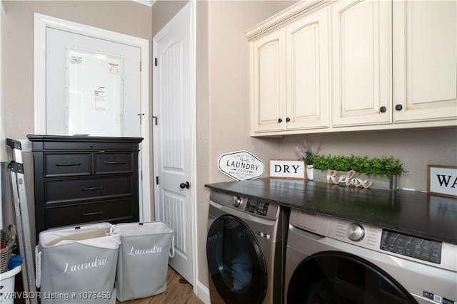 laundry room featuring hardwood / wood-style flooring, cabinets, and independent washer and dryer