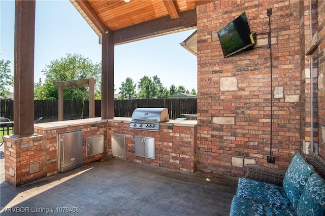 view of patio with exterior kitchen and area for grilling