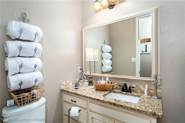 bathroom with toilet and vanity