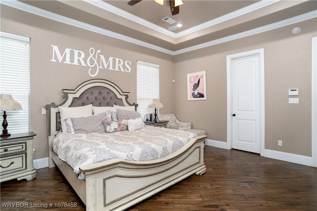 bedroom featuring ceiling fan, dark hardwood / wood-style flooring, crown molding, and a raised ceiling