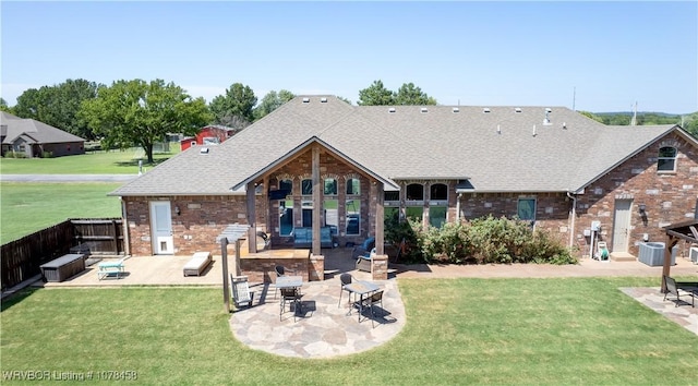 rear view of house featuring central air condition unit, a yard, and a patio