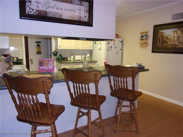 dining space with sink and dark wood-type flooring