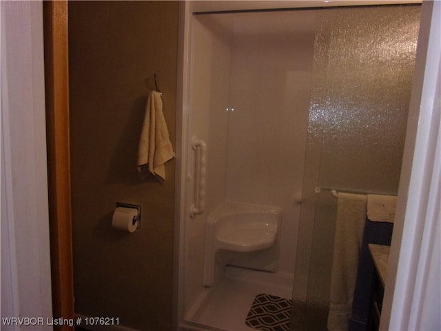 bathroom with vanity and a shower with shower door