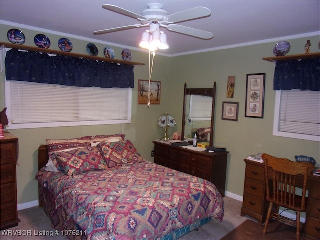 carpeted bedroom with ceiling fan and ornamental molding