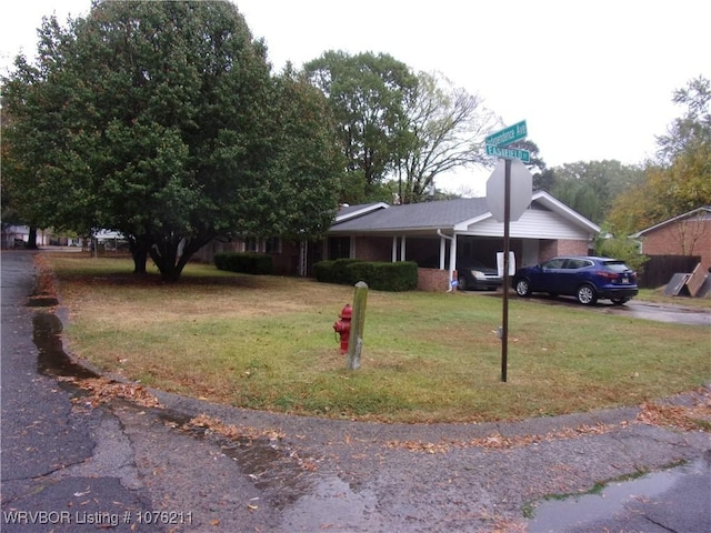 view of front facade with a front yard and a carport