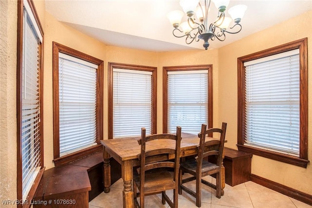 tiled dining area with a notable chandelier