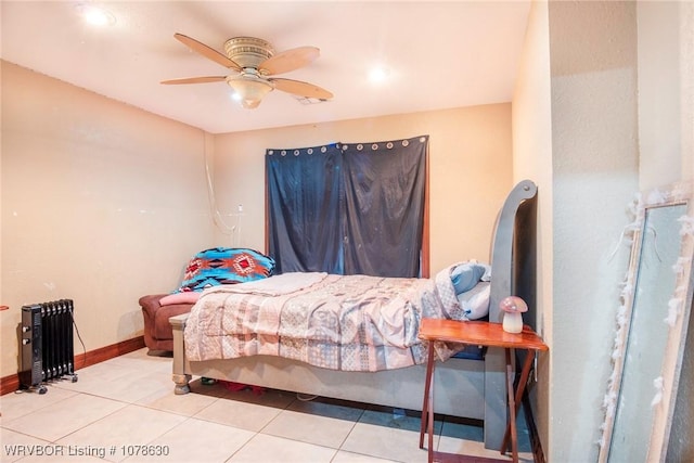 bedroom featuring tile patterned flooring, radiator, and ceiling fan