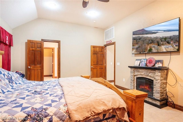 tiled bedroom with lofted ceiling, a fireplace, and ceiling fan