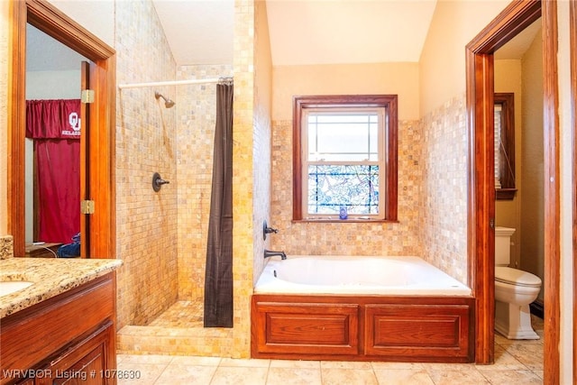 full bathroom with vanity, tile patterned flooring, shower with separate bathtub, and toilet