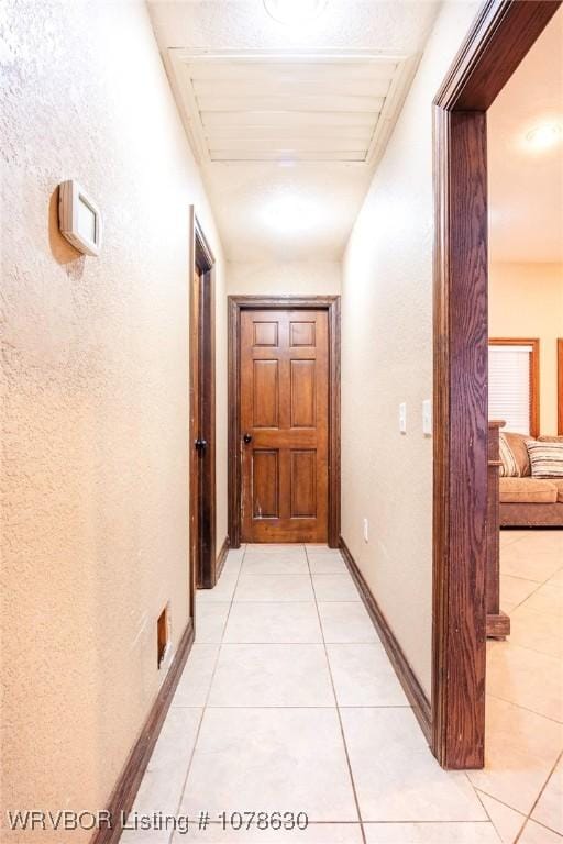 corridor featuring light tile patterned flooring