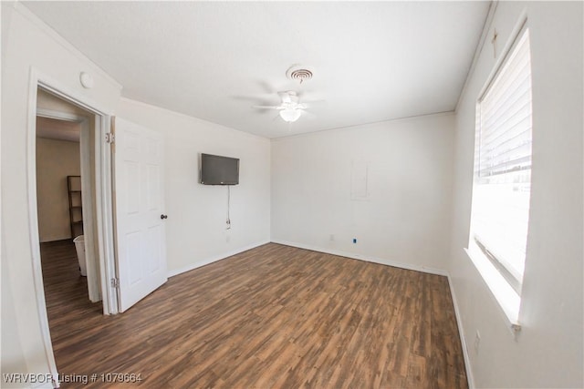 unfurnished room with visible vents, baseboards, a ceiling fan, and wood finished floors