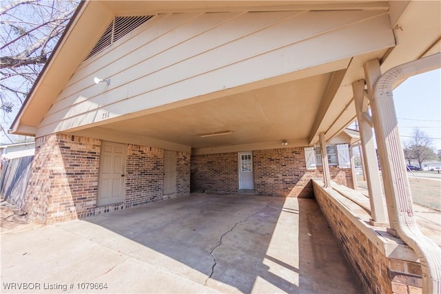 view of patio featuring an attached carport and visible vents