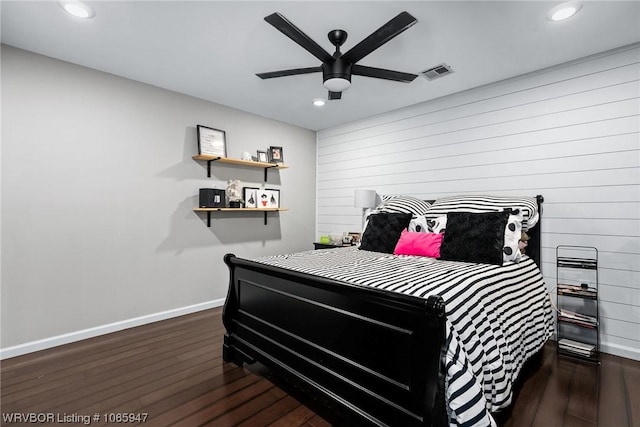 bedroom with ceiling fan and dark hardwood / wood-style floors