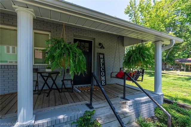 exterior space with covered porch and a lawn