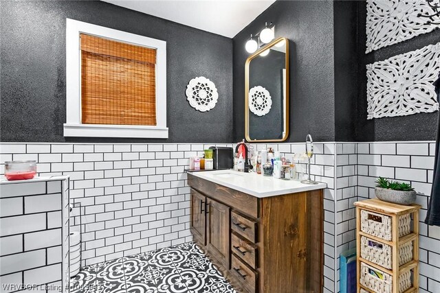 bathroom with vanity and tile walls