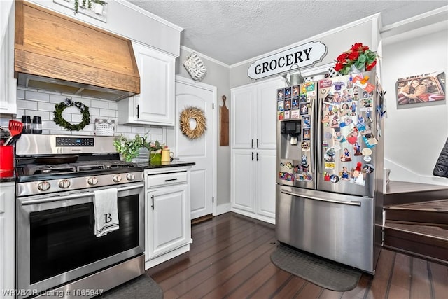 kitchen featuring white cabinets, decorative backsplash, custom range hood, and appliances with stainless steel finishes