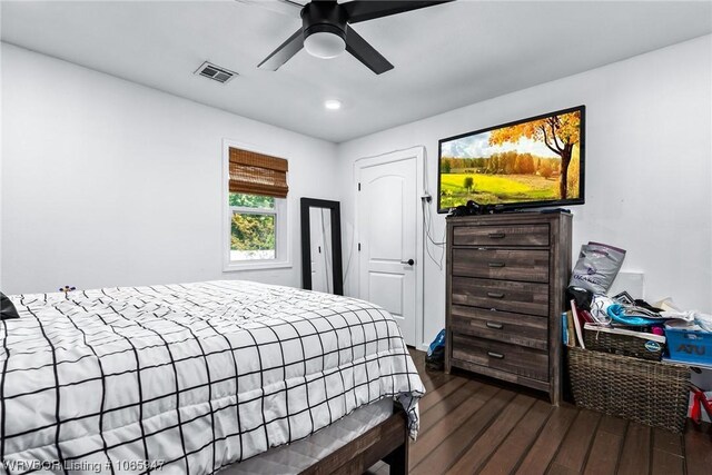 bedroom featuring ceiling fan and dark hardwood / wood-style floors