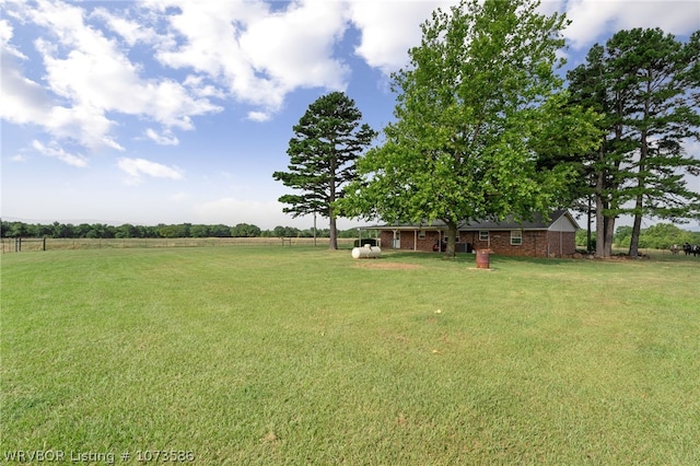 view of yard with a rural view