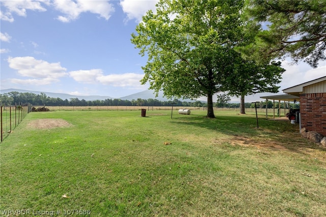 view of yard featuring a mountain view and a rural view