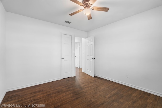 unfurnished room with ceiling fan and dark wood-type flooring