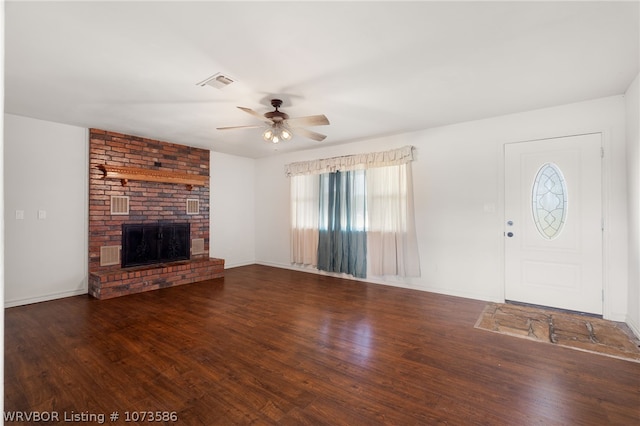 unfurnished living room with a fireplace, dark hardwood / wood-style flooring, and ceiling fan