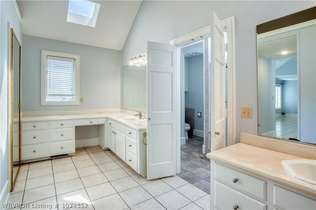 2411 Wyndermere Way, Fort Smith, AR 72903 - full bathroom with a skylight, lofted ceiling, vanity, tile patterned floors, and toilet