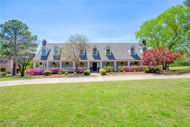 cape cod home with a front yard