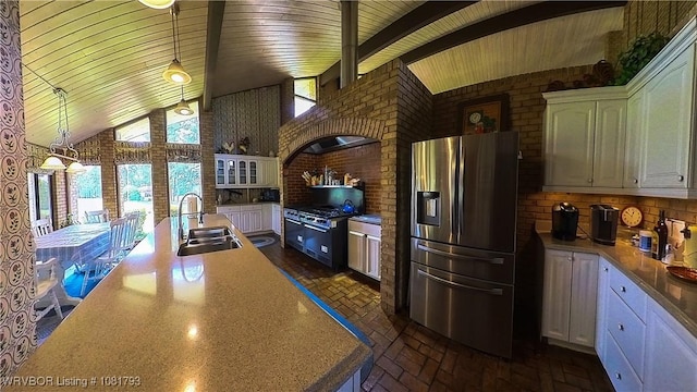 935 County Road 3456, Clarksville, AR 72830 - kitchen with stainless steel fridge, white cabinetry, wood ceiling, tasteful backsplash, and brick wall