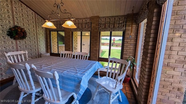 935 County Road 3456, Clarksville, AR 72830 - dining room with wood ceiling and brick wall