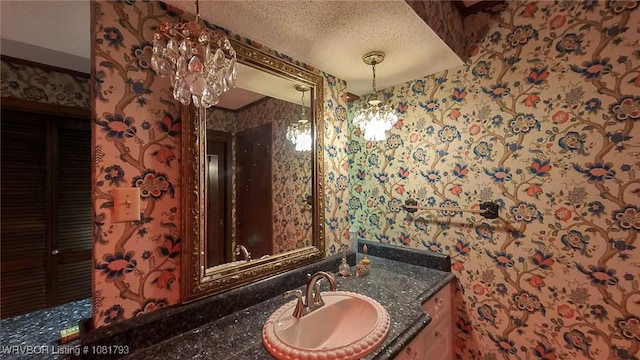 935 County Road 3456, Clarksville, AR 72830 - bathroom with wallpapered walls, vanity, and a textured ceiling