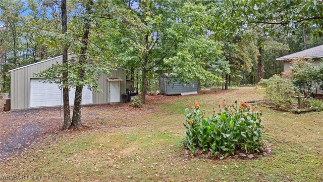 view of yard featuring an outbuilding and a garage