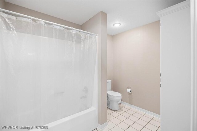 bathroom with toilet, shower / bath combo, and tile patterned floors