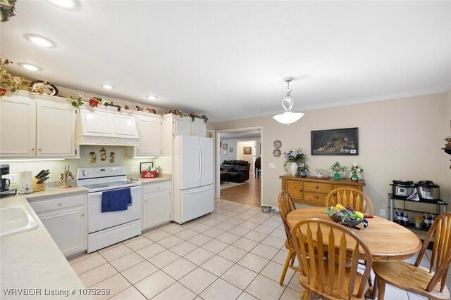 kitchen featuring light tile patterned floors, white cabinets, pendant lighting, and white appliances