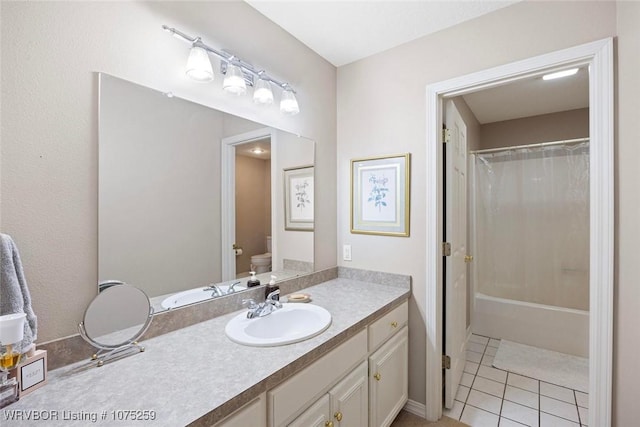 bathroom featuring tile patterned flooring, vanity, and toilet