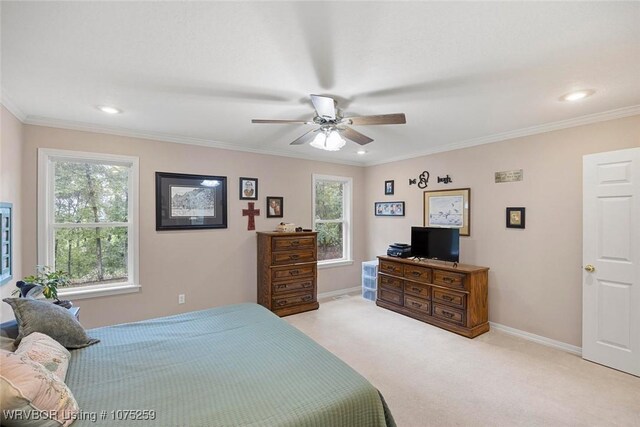 carpeted bedroom featuring ceiling fan and ornamental molding