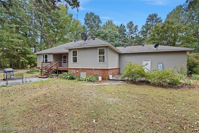 rear view of property featuring a lawn