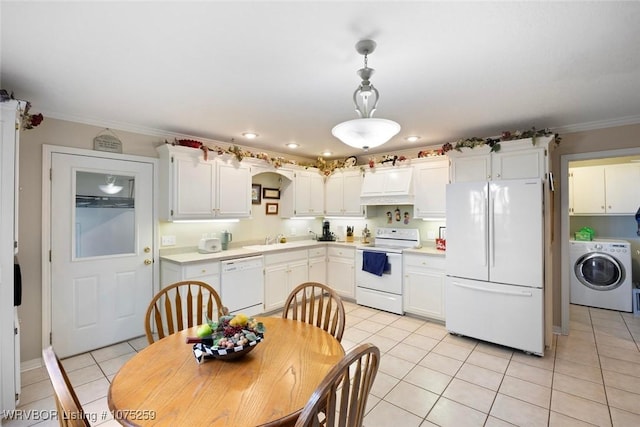 kitchen with washer / dryer, white appliances, decorative light fixtures, and white cabinetry