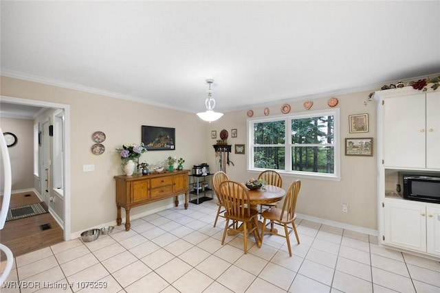 dining room featuring light tile patterned flooring and ornamental molding