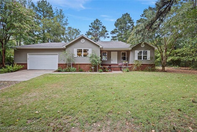 view of front of house featuring a front lawn, covered porch, and a garage