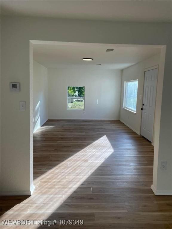 interior space featuring visible vents, baseboards, and wood finished floors