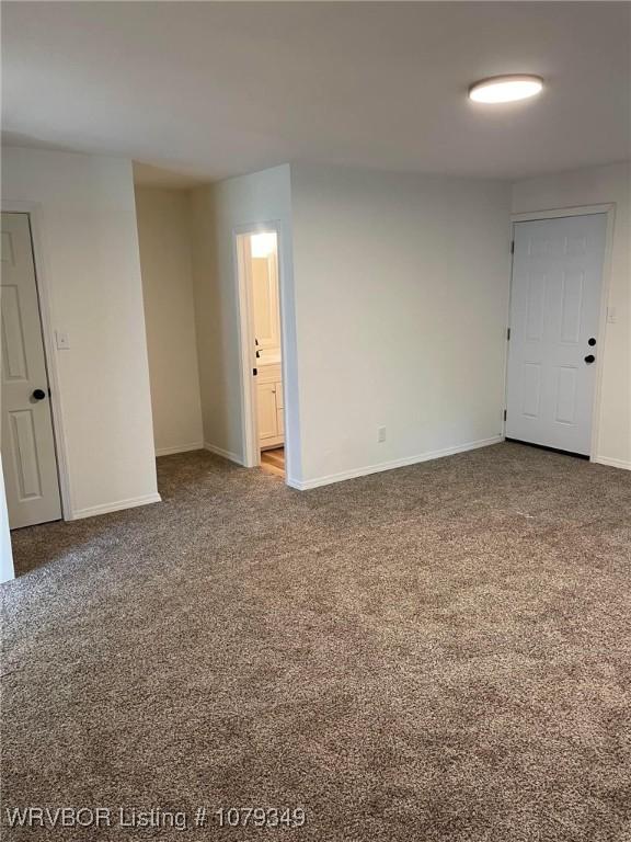 carpeted spare room with baseboards