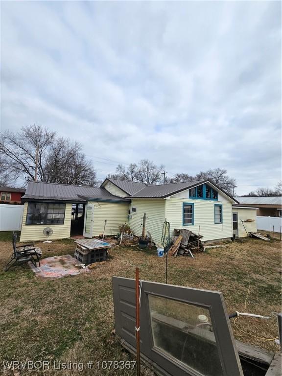 rear view of house featuring a patio area and a lawn