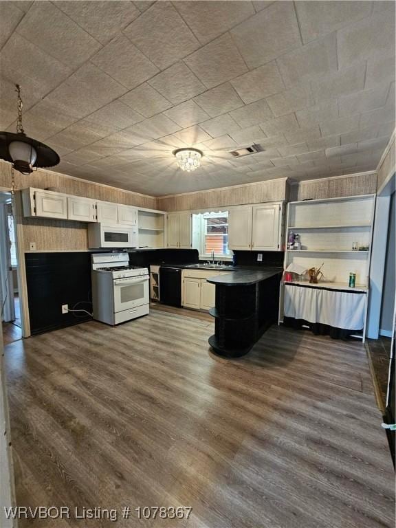 kitchen featuring dark hardwood / wood-style floors, sink, white cabinets, and white appliances