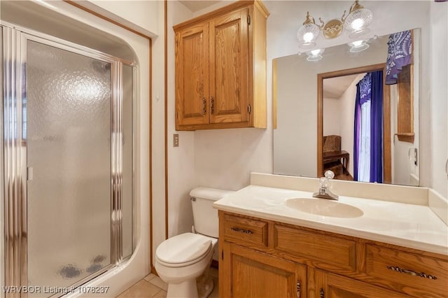 bathroom with tile patterned floors, vanity, toilet, and an enclosed shower