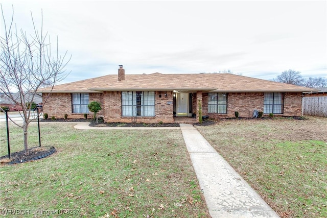 ranch-style home featuring a front yard